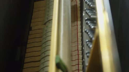 Piano Hammers Striking Strings Close Up