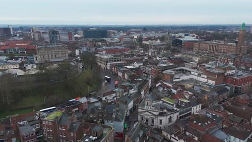 Aerial view of Norwich city showcasing historic streets, churches, and urban scenery