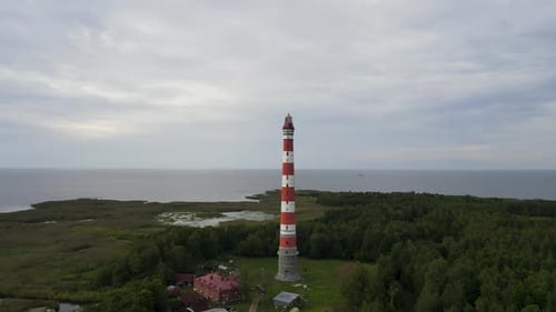 Old lighthouse, around green forest, aerial shot. Remote place of Ladoga lake, Republic of Karelia.