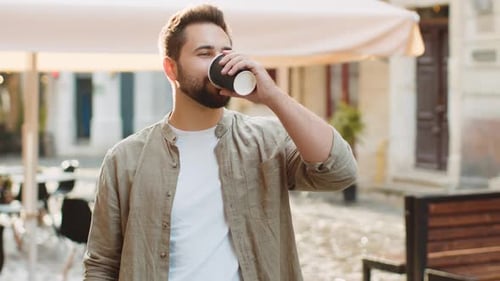 Young Man Guy Enjoying Drinking Morning Coffee Hot Drink Relaxing Taking a Break in City Street