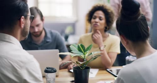 4k video footage of a group of young businesspeople having a meeting in a modern office