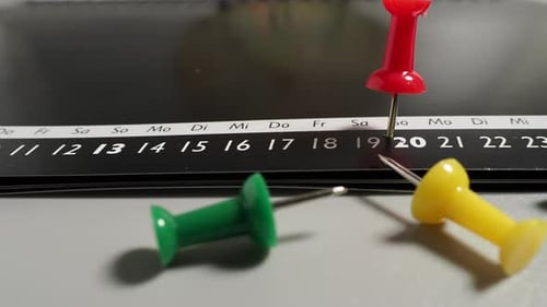 Calendar with push pins. Concept of time and planning.