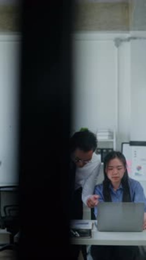 Colleagues Analyzing Data Together in the Workplace