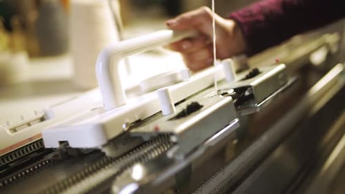 Female Hands Making Knitted Texture on Weaving Machine. Close Up Process Manufacturing