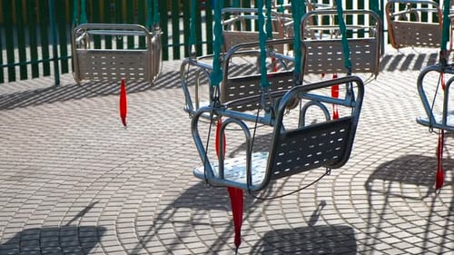 Empty Swing Ride Seats in Amusement Park