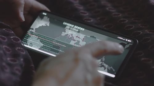 Hand touches phone displaying world data