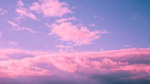 Pink Purple Clouds Moving at Sunrise or Sunset