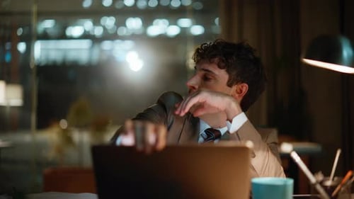 Late Worker Closing Laptop Tired Overtime Work in Night Office Workplace Closeup