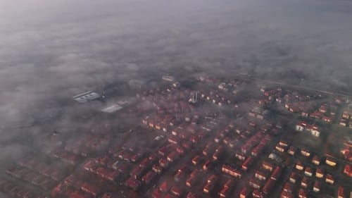 the view of the clouds over the city from the air