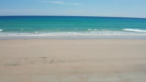 Aerial view of scenic landscape of desert island with white sand beach, crystal clear sea water an