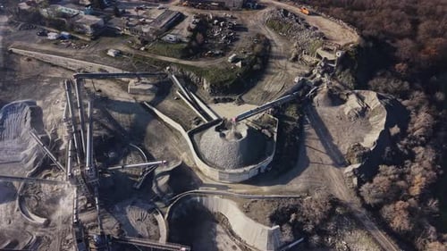 View of a quarry with machinery and storage areas during the day