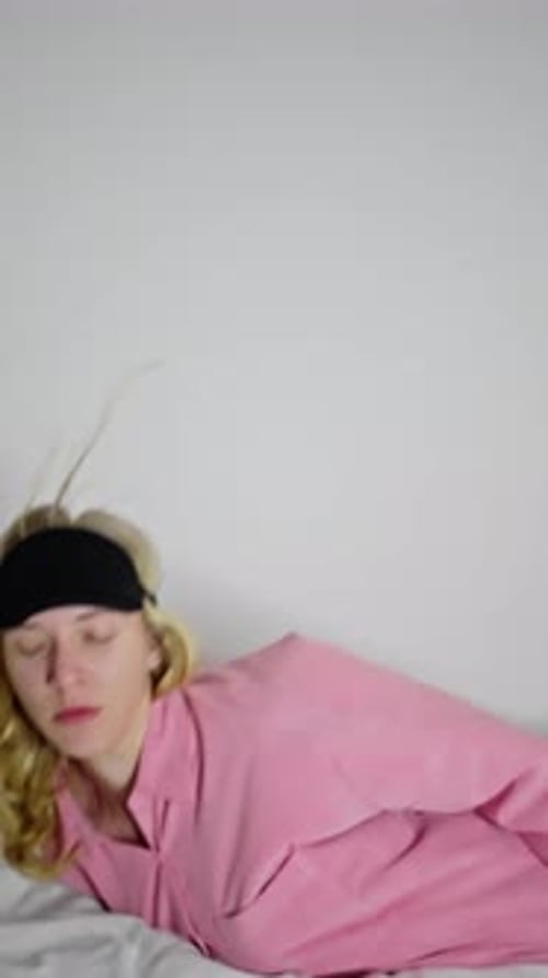 Exhausted European Girl Falling Back to Keep Sleeping on the Comfortable Bed
