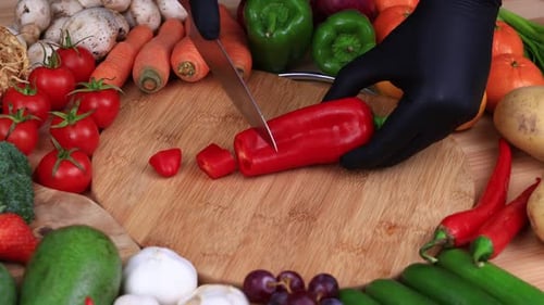 Dicing Red Pepper With Fresh Fruits and Vegetables