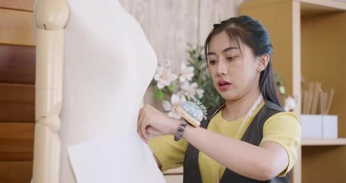 Fashion Designer Creating Pattern on Dress Form