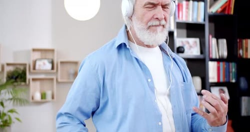 Senior Man Enjoying Music, Playing Air Guitar