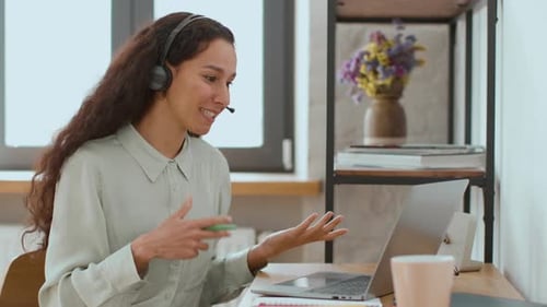 Woman Wearing Headset Talking During Video Conference