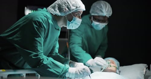 Doctor, people and patient in theatre at hospital for operation with help, support and trust
