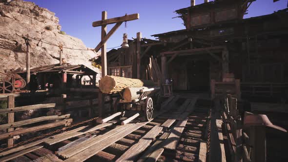 Historic Wooden Structure with Log Cart in a Mining Town at Sunset ...