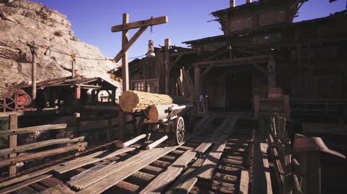 Historic Wooden Structure with Log Cart in a Mining Town at Sunset ...