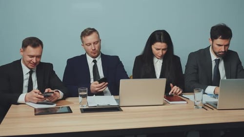Business Team Distracted By Smartphones