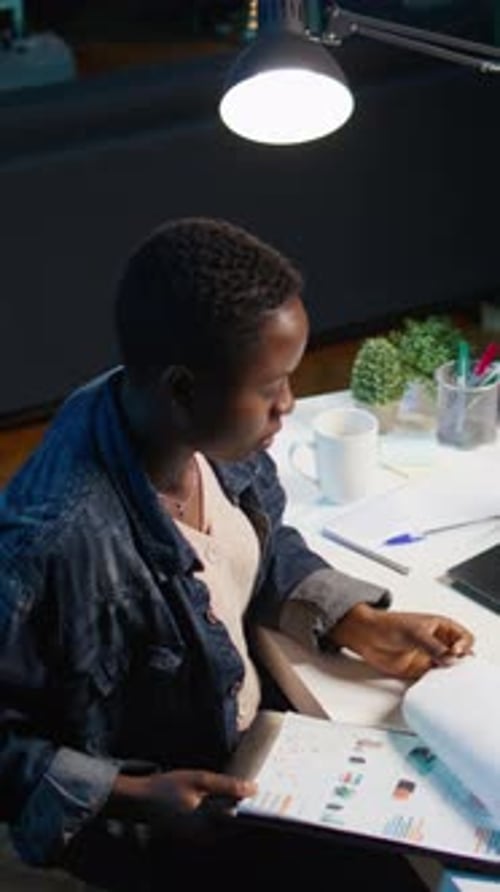 Vertical Video Teleworker Doing Research Analysis for Startup Organization