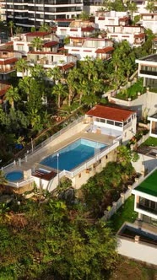 Vertical Video Luxurious Homes Aerial View of Villas and Complexes with Pools in a WellMaintained