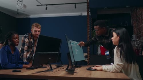 Diverse Team Collaborates on Code in Modern Office