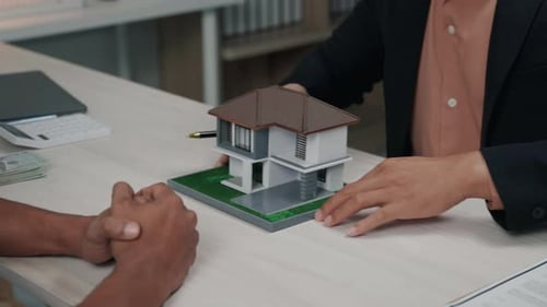 Business people seller explain and calculate to who buying real estate house properties.