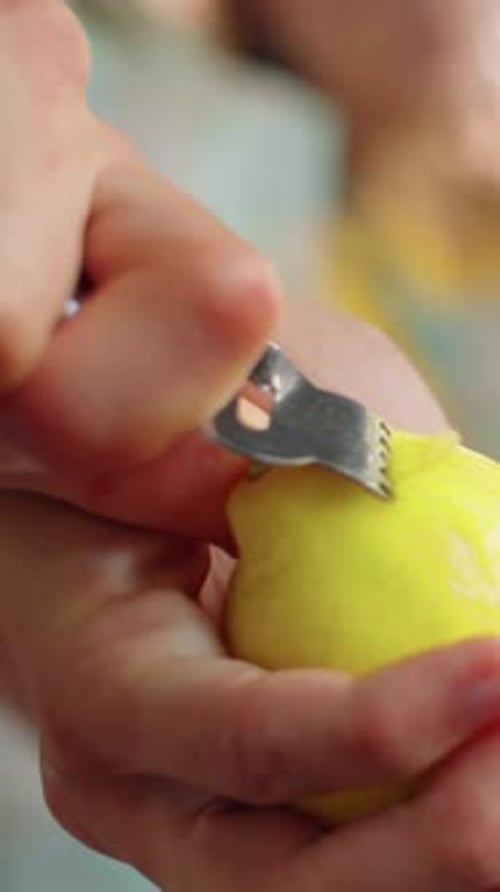 Close-up of Unrecognizable Hand Zesting Lemon