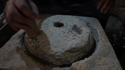 Old Millstone Turning Manually, Covered in White Flour, Handcrafted Like in Ancient Times