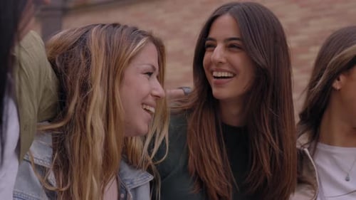 Diverse Group of Joyful Generation z Friends Having Fun Standing Embracing on City Street Together