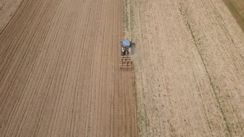 Agricultural Work with Tractor Preparing Field for Harvesting