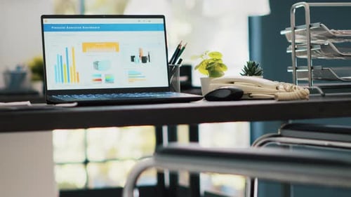 Wheelchair in Inclusive Office and Laptop Showing Marketing Report Data