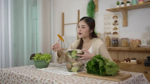 Young Woman Eats Salad in Bright Kitchen