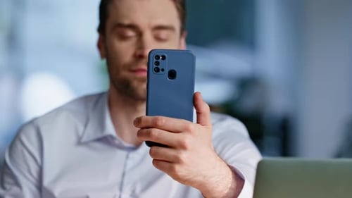 Relaxed Freelancer Browsing Cellphone Sitting Workplace Closeup Smiling Man