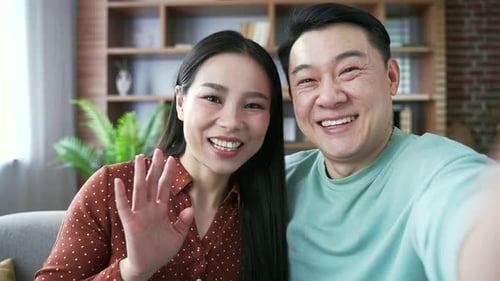 Happy Couple Waving on Video Call from Home