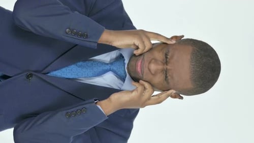 Vertical Video of Tense African Businessman with Headache on White Background