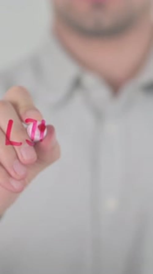 Man Writes Limited Offer with Red Pen on Glass