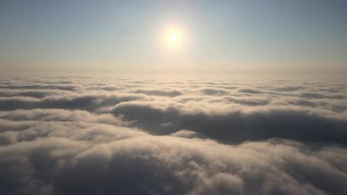 Aerial View of Fluffy Clouds Under Bright Sun