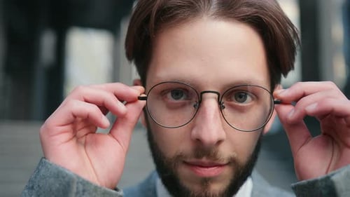 Attractive Male Caucasian Boss Taking on Glasses While Looking at Camera and Smiling Portrait of