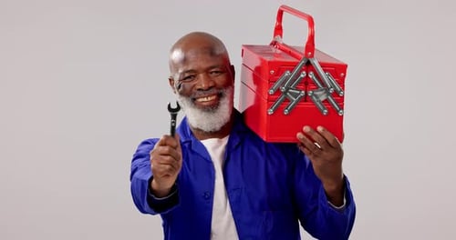 Construction worker, face and tool box with handyman, smile and black man in studio