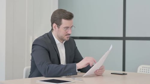 Man Reads Good News in Office