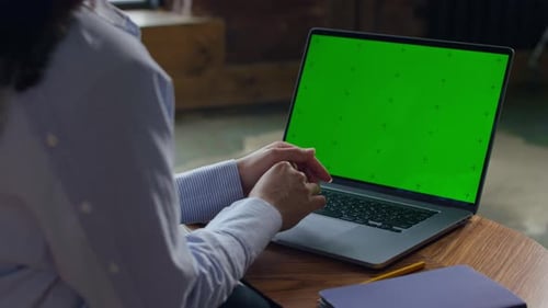 Laptop with Green Screen Mockup at Desk