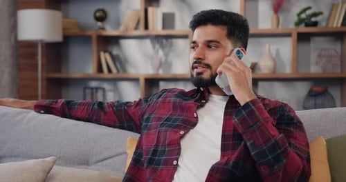 Man Chatting Happily on Phone at Home