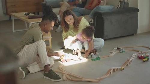 Family Playing with Train Set in Home