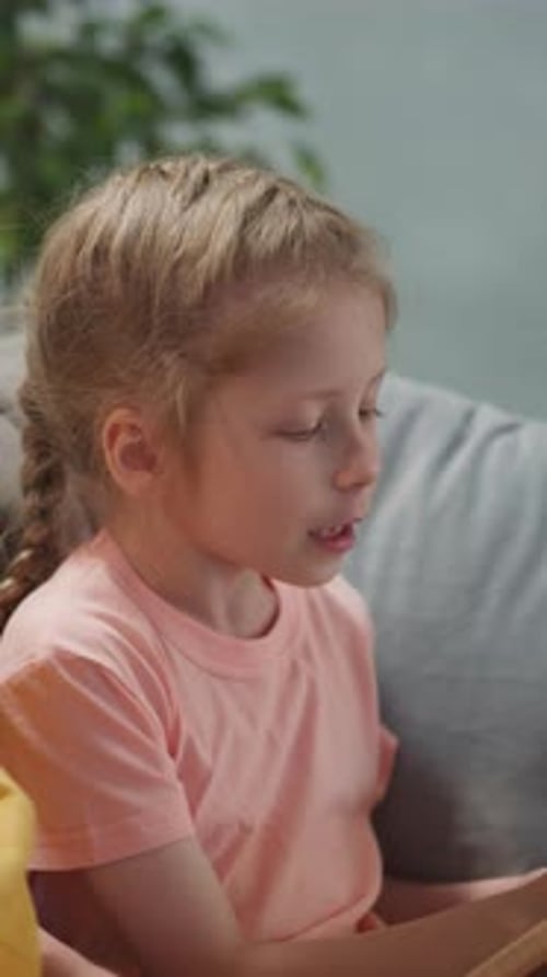 Girl with Blonde Hair Reading at Home