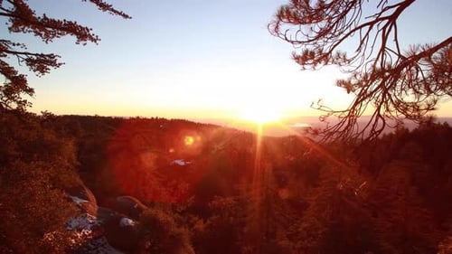 A time-lapse of the sun setting over the mountains.