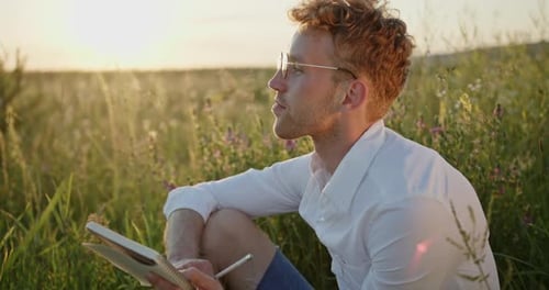 Guy Writer Artist Dressed in a Shirt Writes Himself with Inspiration with Pleasure Writes Poems and