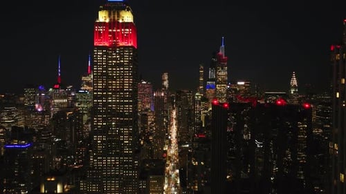 Aerial Views Capture New York City Skyline at Night Showcasing the Empire State Building Glowing in