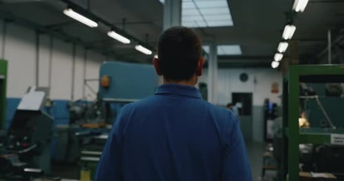 Slow motion of specialist is walking satisfied with his work in industrial factory of production o